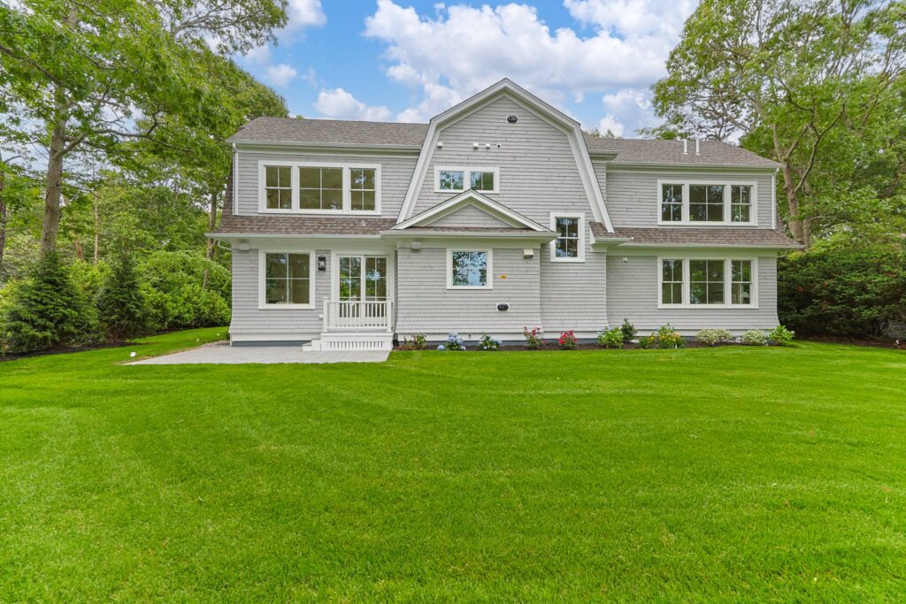 Rear lawn and exterior of 640 Poponessett Road